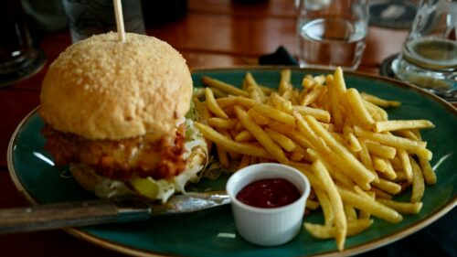 A plate with a sandwich and french fries on it