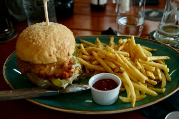 A plate with a sandwich and french fries on it