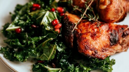 cooked meat with green vegetable on white ceramic plate