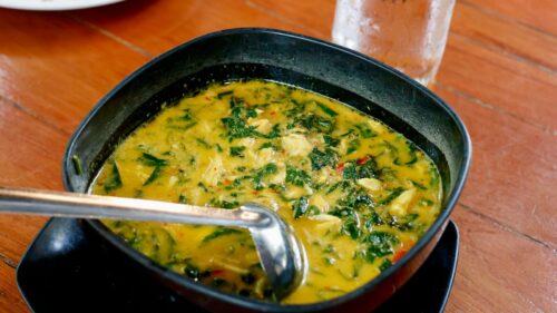 a bowl of soup with a spoon in it